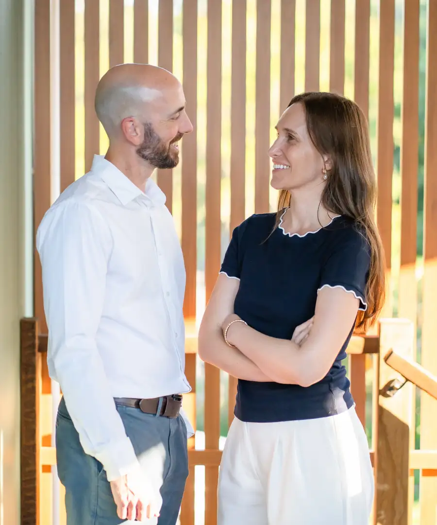 Two members of the Grove Support Services team in conversation in warm afternoon light