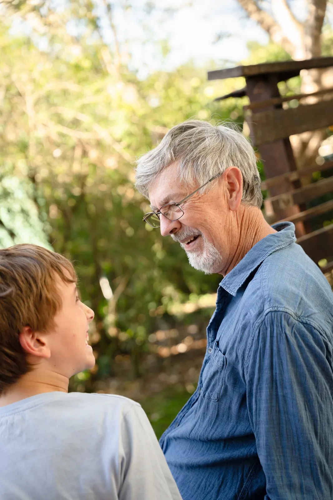 Two adults in conversation outdoors in warm afternoon light